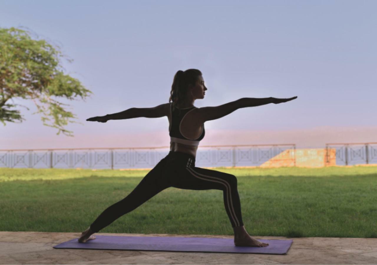 Moevenpick Resort & Spa Dead Sea Sweimeh Exterior photo A woman practicing yoga